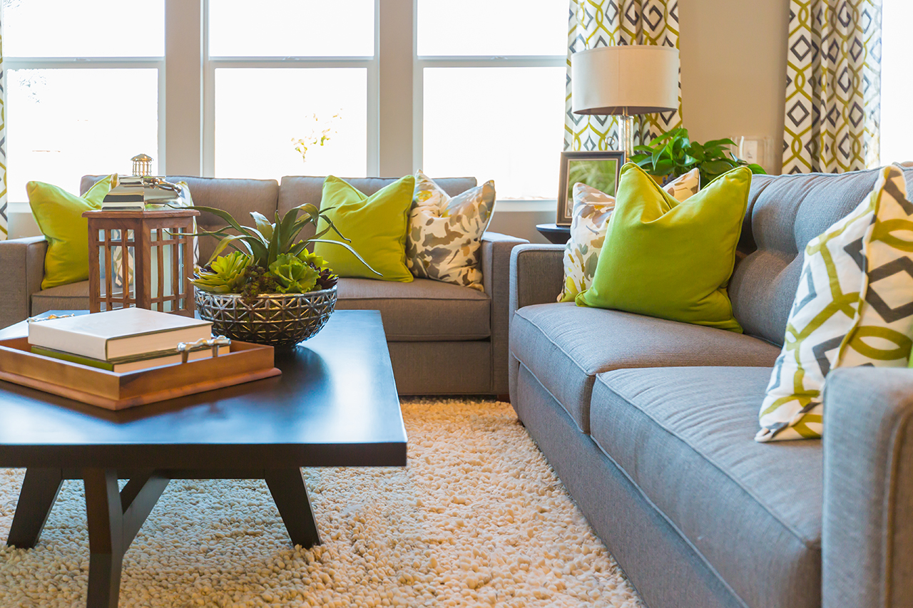 Nice Livingroom with coffee table and nice green pillows.